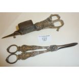 Silver plated grape scissors, and an antique pair of silver plated candle snuffers