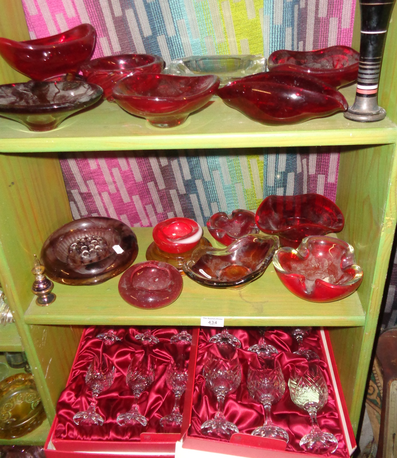 Three shelves of assorted glassware, inc. red glass Whitefriars ashtray and bowls