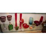 Shelf of assorted coloured glass, inc. paperweights