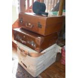 Four vintage leather suitcases with canvas covers and a vintage drum shaped leather and