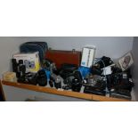 Shelf of assorted cameras and accessories