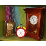 A Mickey Mouse alarm clock, an Anniversary clock and a mantle clock