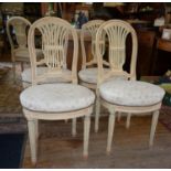 Set of six painted salon chairs with open lyre backs and upholstered seats on fluted legs