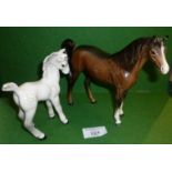 A Beswick dapple grey foal and a Beswick brown gloss stallion