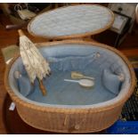 Oval lidded wicker basket with fitted interior and child's parasol