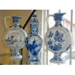Pair of Delft pottery moon flasks and a Delft vase and cover, 27cm