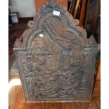 An arch topped cast iron fireback with relief figurative decoration, c1910