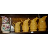 Graduated set of four Victorian harvest jugs and another