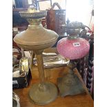 Victorian oil lamp with pink opaque glass reservoir and a brass column oil lamp base