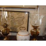 Two brass oil lamps with glass shades