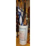 Ceramic umbrella stand with modern umbrellas and an African walking stick