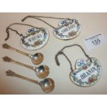 Set of three china decanter labels by Crown Staffordshire, and a set of three silver salt spoons