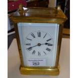 Brass carriage clock with enamel dial and striking on a gong, 5½ " tall