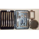 Cased set of six silver pistol grip handled butter spreaders, silver photo frames, etc. all silver