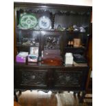 Late Victorian carved oak dresser, the upper section having shelves and central cupboard over two