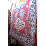 Large handmade Caucasian style rug on red ground 2.3m x 1.4m