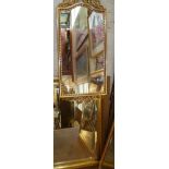 Large gilt frame wall mirror with bevelled edge and another having swags to arched top