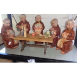 Five Western Germany pottery ale flasks in the form of Monks around a refectory table