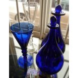 Bristol blue glass wine glass, two similar bottles and a tall clear wine glass with twist stem