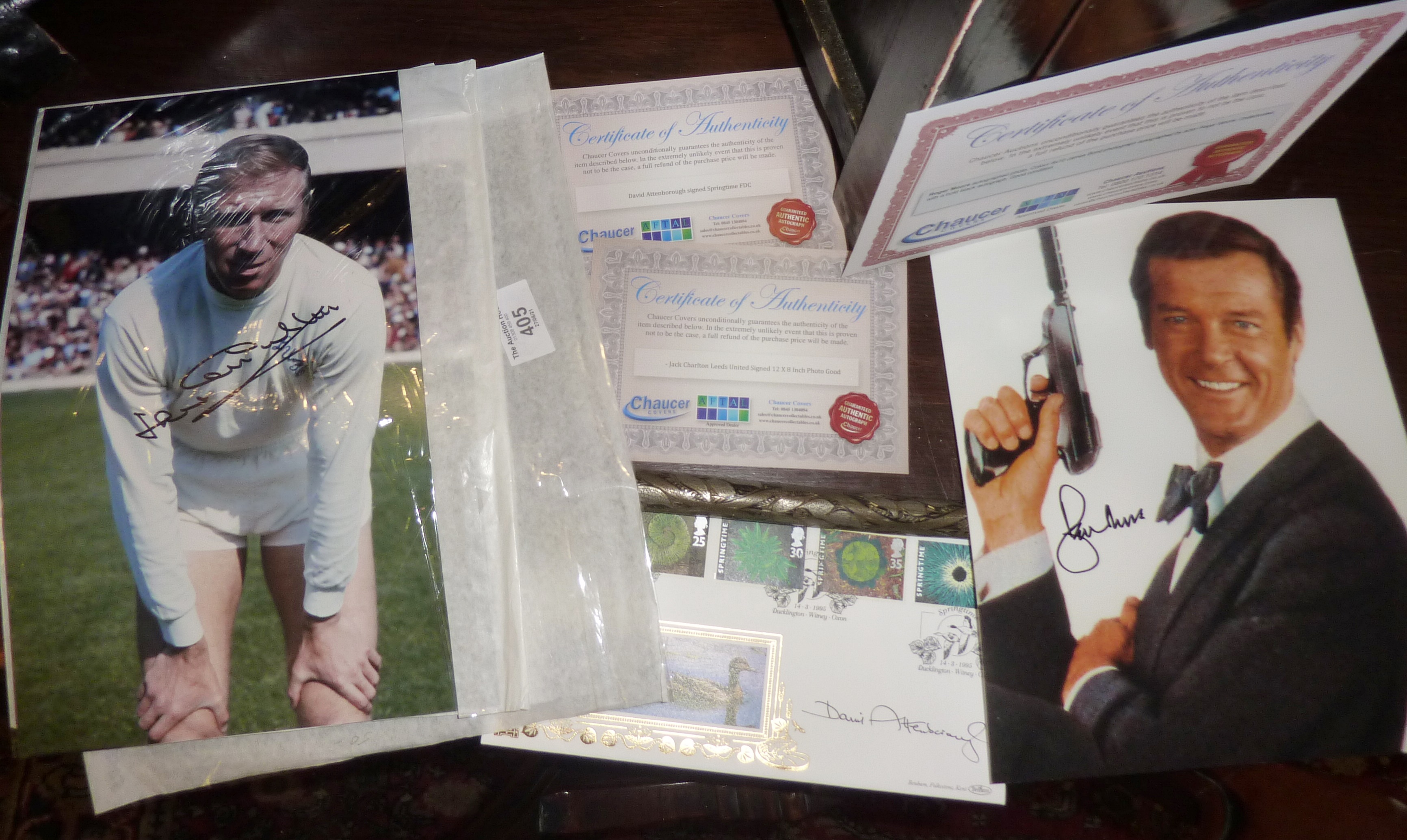 Autographed photos of Roger Moore and Jack Charlton together with a 1st Day Cover signed by David