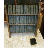 Small bookcase containing a collection of miniature books by Shakespeare