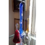 Tall blue glass lily vase, a cranberry glass bell and another