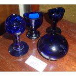 Three antique Bristol blue glass eye baths and similar paperweight