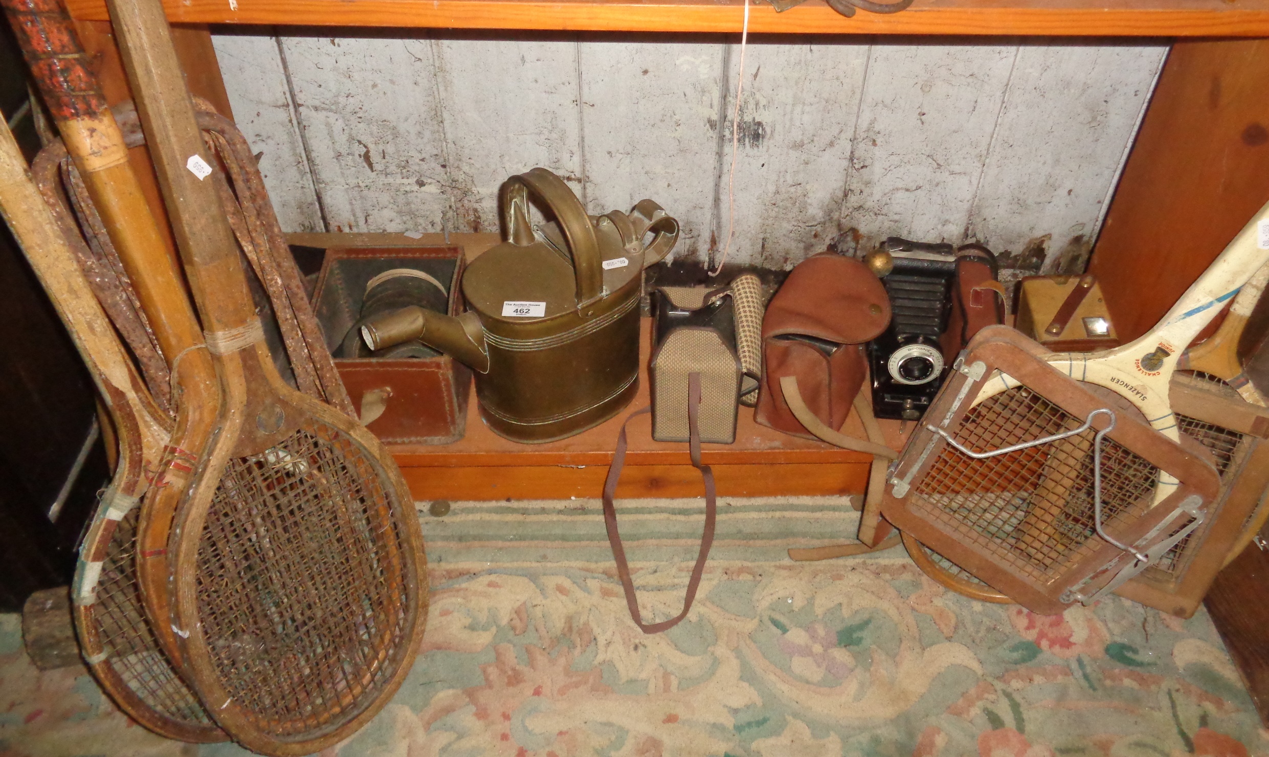 Brass servants water jug, painted tennis rackets, part croquet set and four cameras with a gas mask