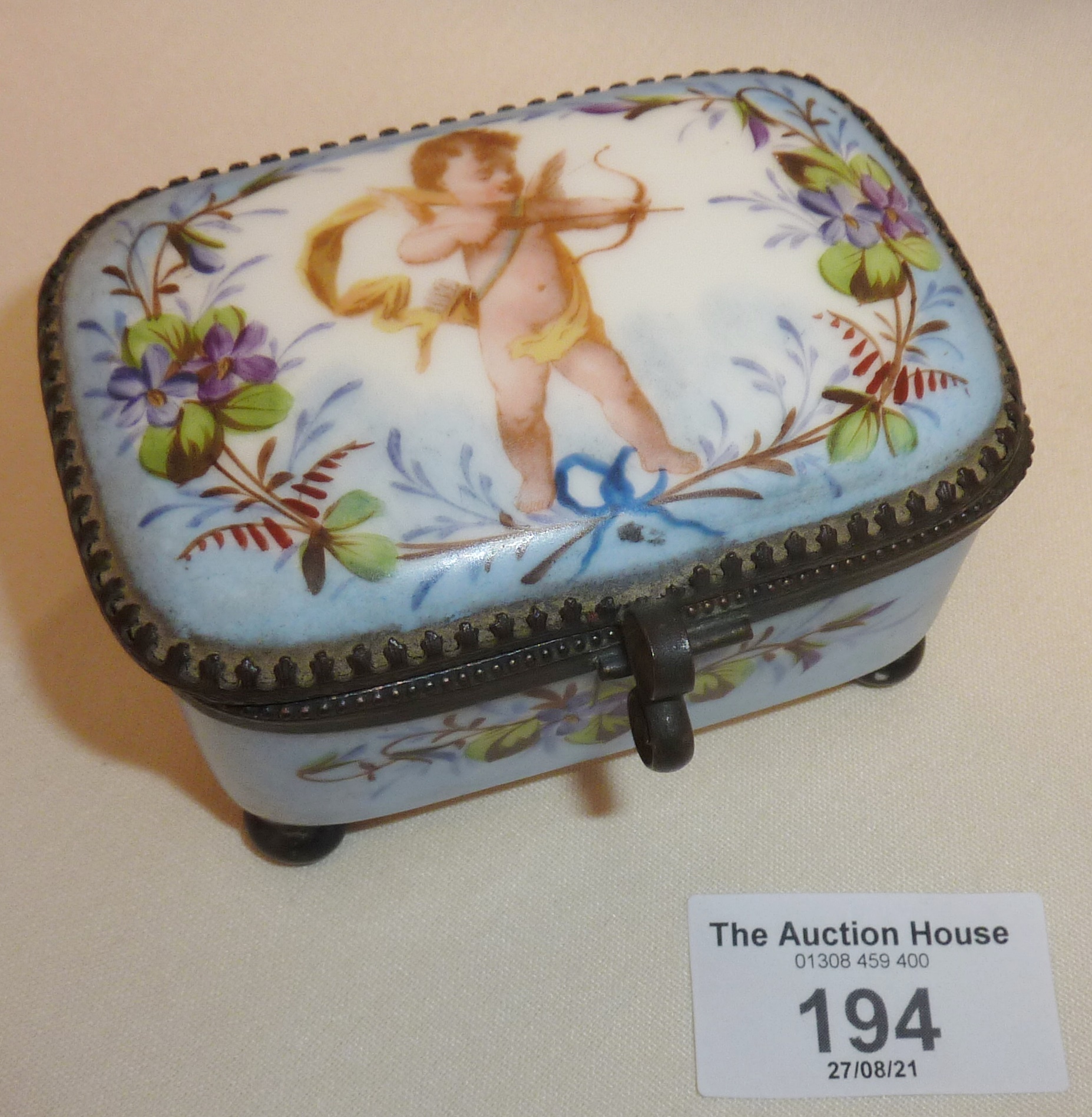 Continental porcelain trinket box decorated with a hand-painted cupid to lid