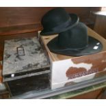 A Resistol cowboy hat in box, a bowler hat and a tin trunk