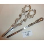 Silver plated grape scissors and an ornate white metal apple corer