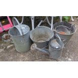 Two galvanised watering cans with roses and three buckets