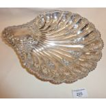 Large silver scallop shaped dish standing on 3 feet, with pierced and chased decoration. Hallmarked