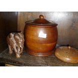 Kitchen treen, a turned fruitwood storage jar or barrel, another wooden pot and a carved elephant