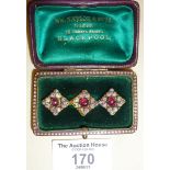 Georgian gold brooch in case, set with red stones and enamelled porcelain (some chips)
