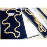 Pearl necklace in case with 9ct gold clasp, approx. 24.5" long. Together with another (faux