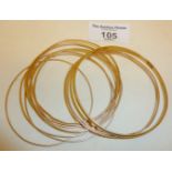 Eleven 9ct gold bangles (one marked, the rest untested), approx. 32g. in weight