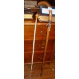 A Victorian sword stick disguised as a wooden walking stick together with a walking cane made from