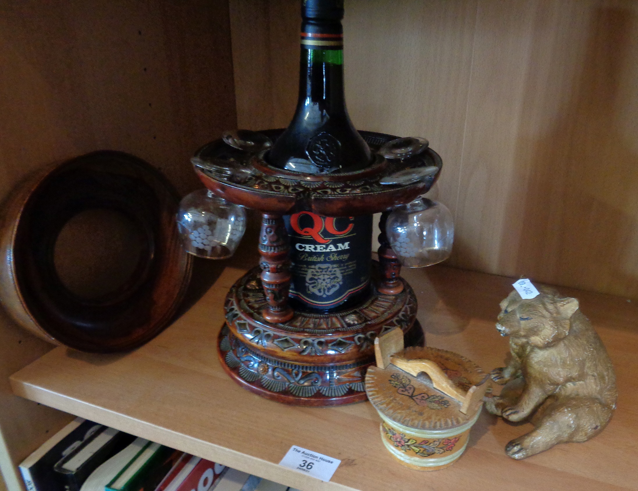 Carved and varnished wood sherry dispenser with glasses, a bear and two other items