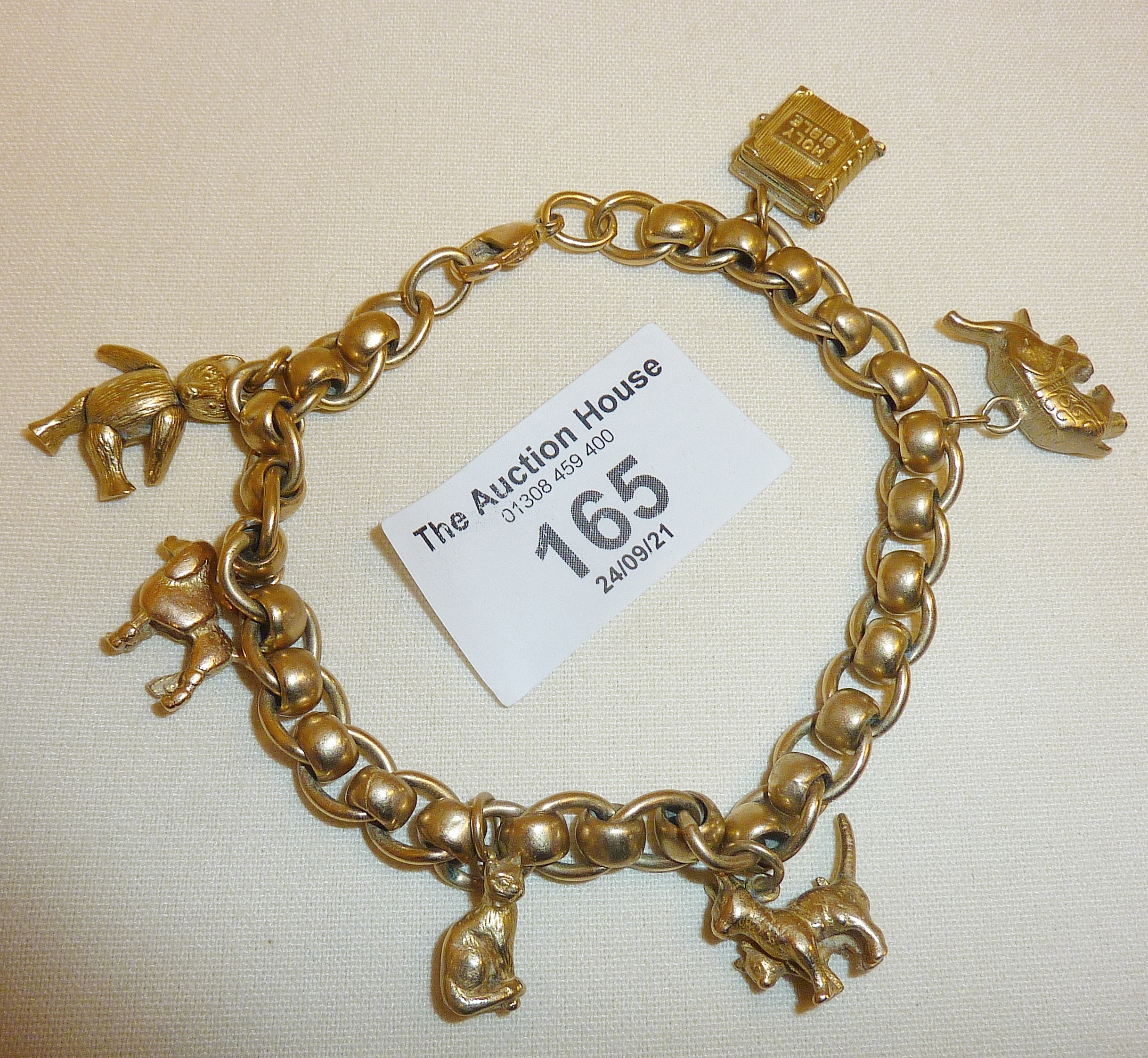 9ct gold heavy charm bracelet and charms - some opening. Approx. 43g in weight