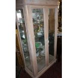 Tall two-door display cabinet in limed beech finish