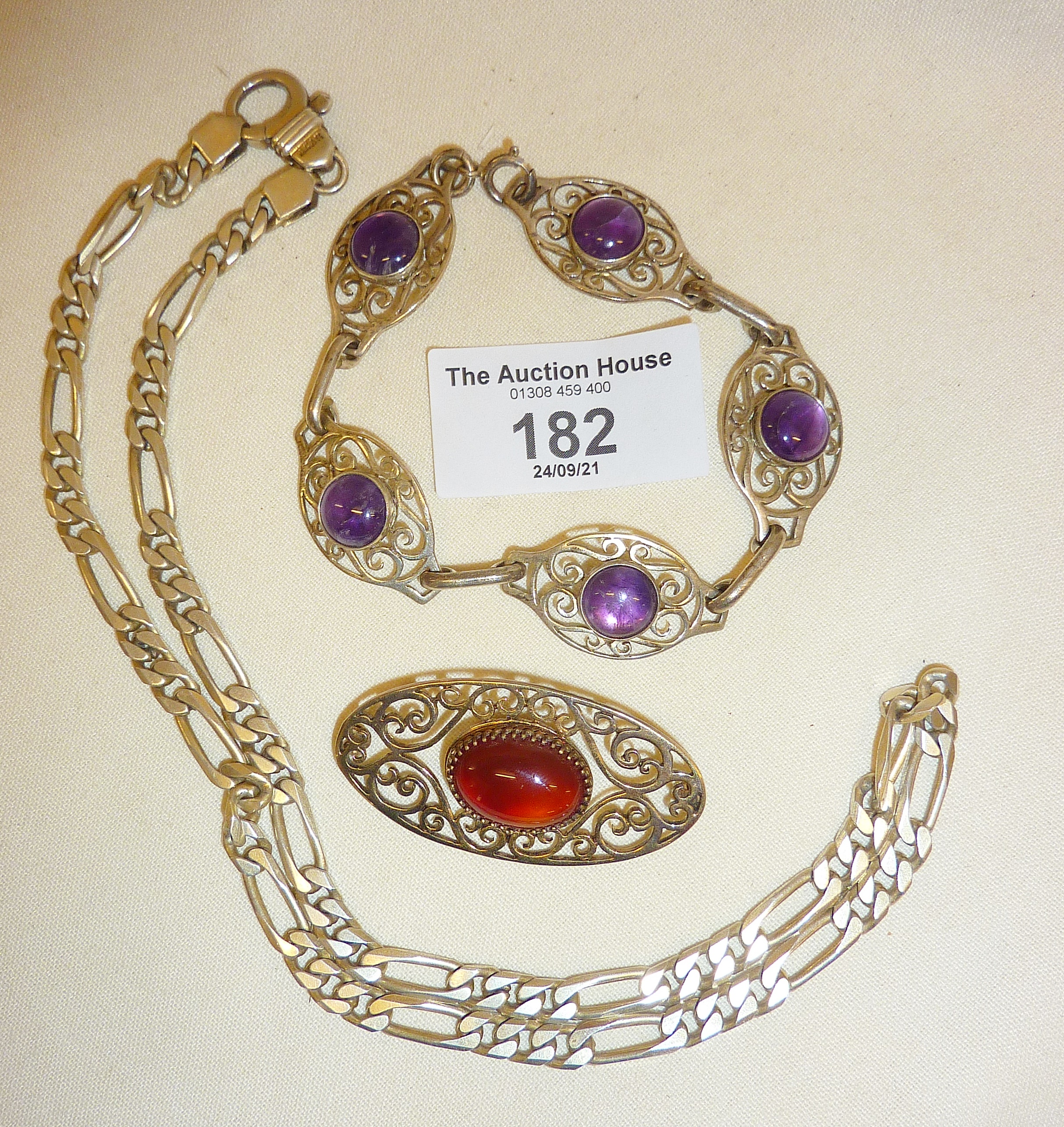 Sterling silver chain link necklace, amethyst and silver bracelet, and a silver brooch (missing