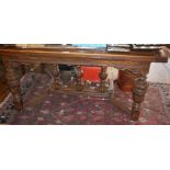 Large refectory-style draw leaf dining table on carved legs