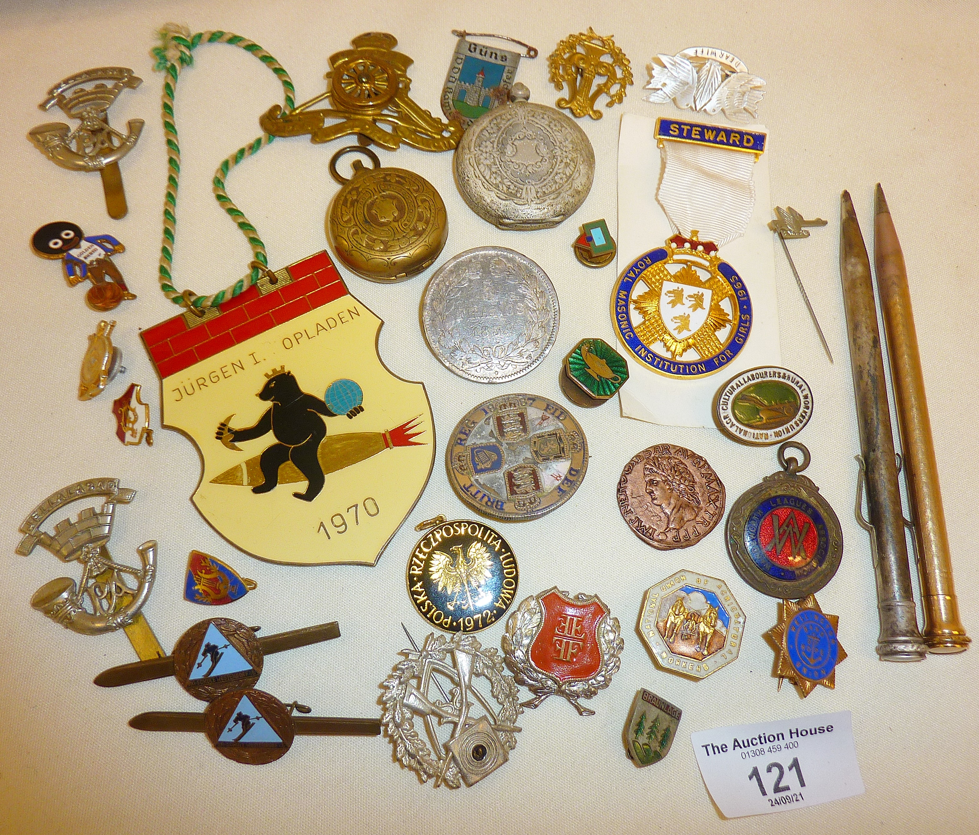 Assorted badges, some mounted silver coins, military cap badges, Eversharp pencils, etc.