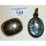 Victorian jet mourning pendant inlaid with mother of pearl, and a tortoiseshell brooch with fine