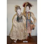 Two French dolls in traditional costume on wooden plinth