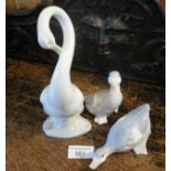A Nao goose figurine and two others