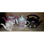 A novelty teapot and three other teapots