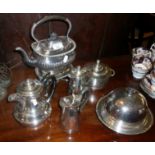 Silver-plated kettle on stand, three jugs, a muffin dish and lidded sugar bowl