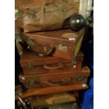 Three leather suitcases and a set of four lignum vitae bowls